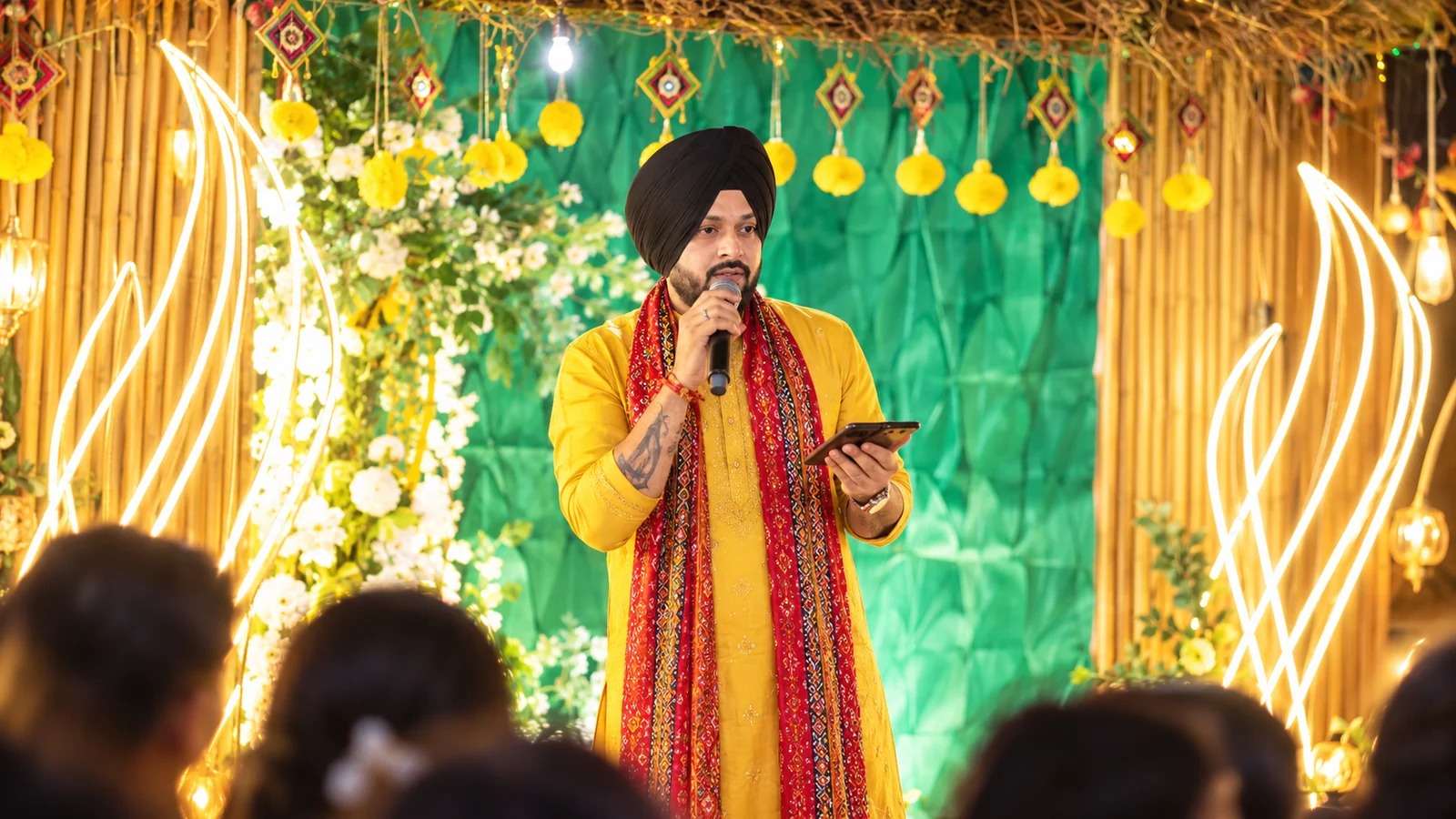 Host presenting in traditional attire for an Indian festive exhibition and showcase